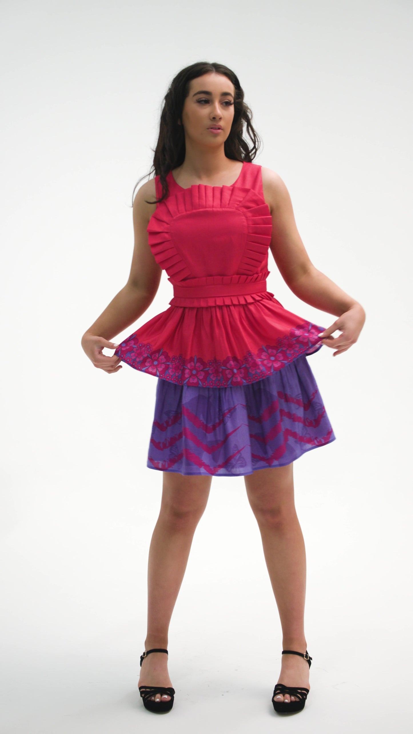 PRODUCT DESCRIPTION Premium silk cotton linen, unique sleeveless mini dress with a tiered skirt, exclusive to MAZASHIE. Contrast tiered skirt with vibrant Placement prints on voluminous panels. The pleated body ruffle adds a luxurious look to the dress. Crew neckline and signature detachable, adjustable self-fabric belt. This dress is close-fitting. Invisible back zip closure. Fully lined in soft cotton.