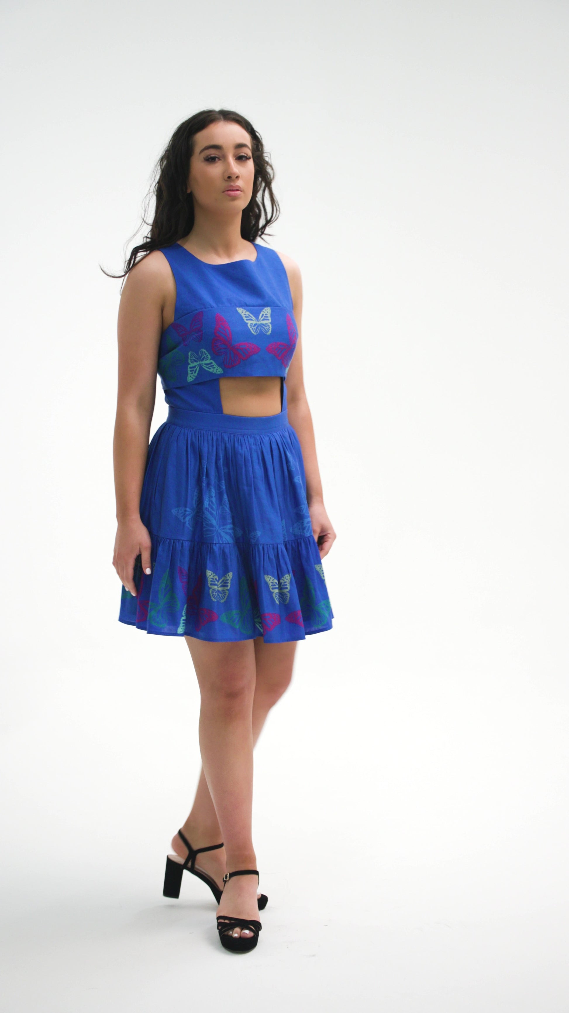 PRODUCT DESCRIPTION  Premium silk cotton linen, unique sleeveless cut-out detail mini dress exclusive to MAZASHIE.  Vibrant Placement print on the bodice band and on the voluminous skirt.  Cut out detail at the midriff of front and back bodice with bust band tie continues to back and tied at the back.  The elasticated waistband makes a perfect fit.  The elasticated backband makes a perfect fit.  The skirt ruffle adds a playful look to the dress.  Invisible back zip closure at skirt.