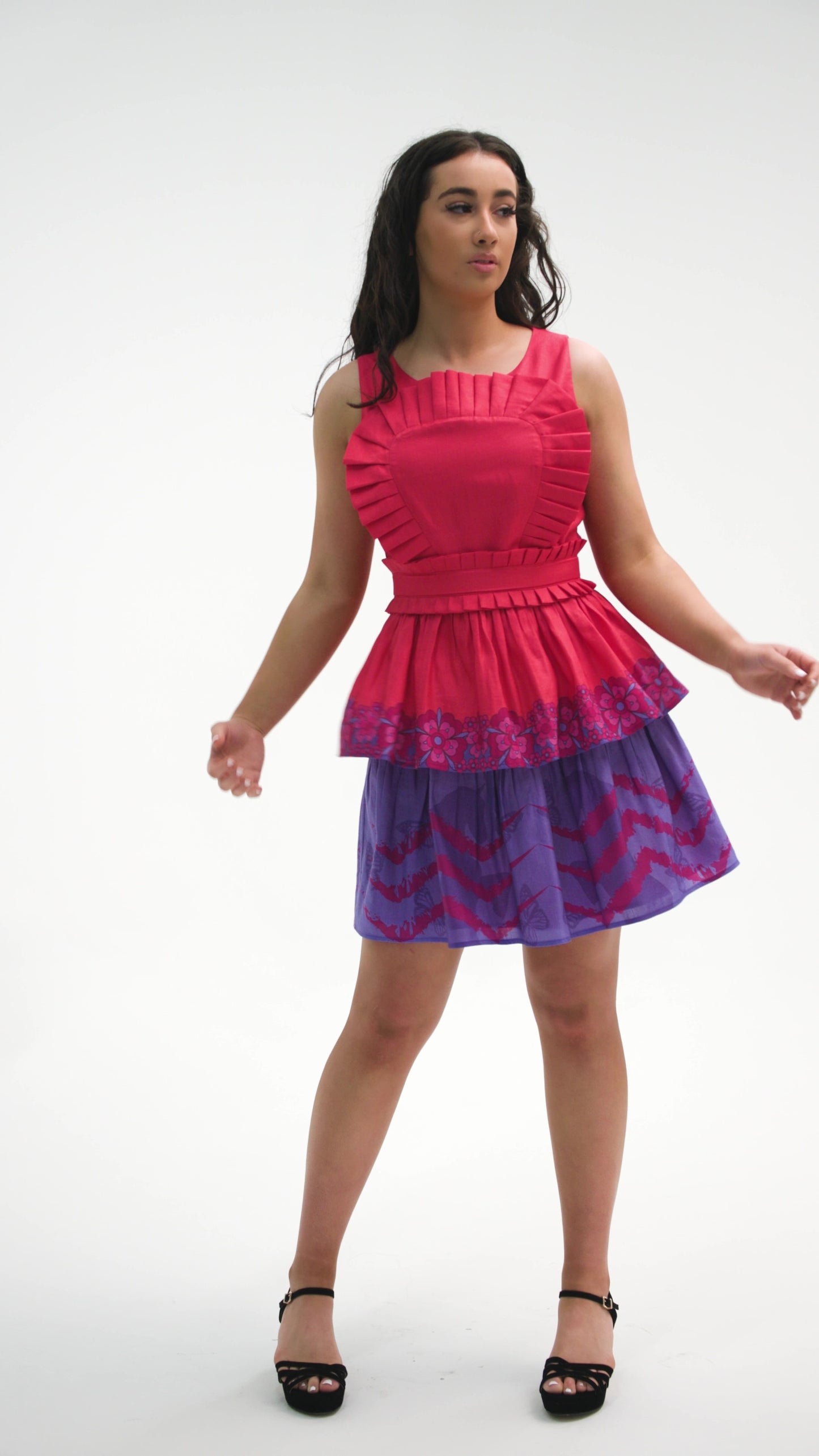 PRODUCT DESCRIPTION   Premium silk cotton linen, unique sleeveless mini dress with a tiered skirt, exclusive to MAZASHIE.  Contrast tiered skirt with vibrant Placement prints on voluminous panels.  The pleated body ruffle adds a luxurious look to the dress.  Crew neckline and signature detachable, adjustable self-fabric belt.  This dress is close-fitting.  Invisible back zip closure.  Fully lined in soft cotton.   