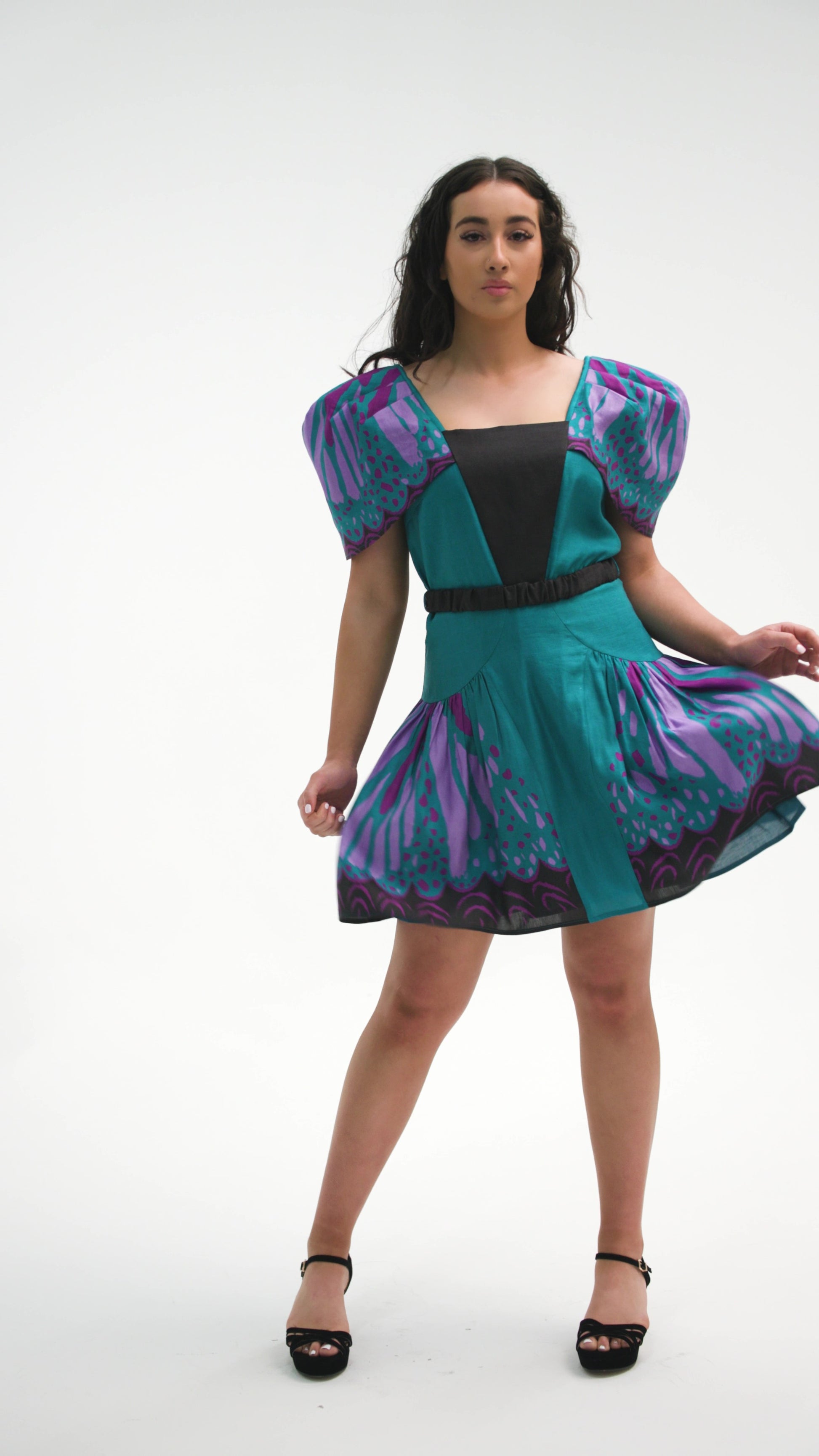 PRODUCT DESCRIPTION   Premium silk cotton linen, unique square neck mini dress with voluminous sleeves, exclusive to MAZASHIE.  Vibrant Placement print on sleeves and on the voluminous skirt.  Voluminous sleeves add a luxurious look to the dress.  Contrast front yoke.  The elasticated contrast waist belt makes a perfect fit.  Invisible back zip closure.  Shoulder retainers at each side of the shoulder to snaped through the bra straps to keep the dress in place.  Fully lined in soft cotton.   