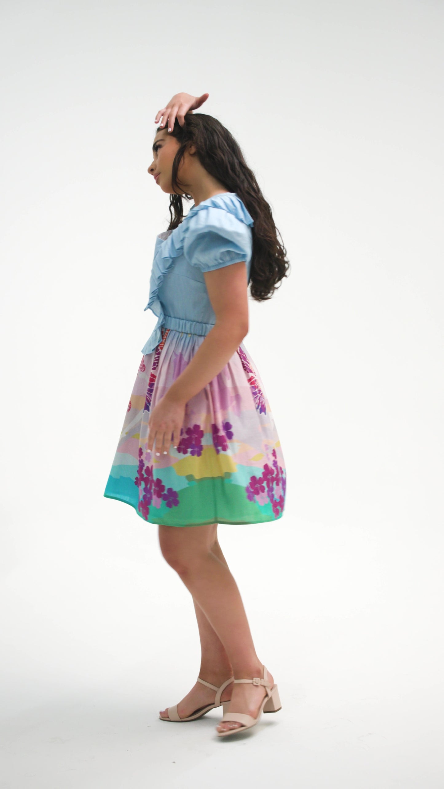 PRODUCT DESCRIPTION   Premium silk cotton linen, unique square neck mini dress with short puff sleeves exclusive to MAZASHIE.  Pastel colour mini dress with ‘magical dream story’ Placement prints on the voluminous skirt.  Pleated body ruffles add a luxurious look to the dress.  The elasticated self-fabric waist belt makes a perfect fit.  Invisible back zip closure.  Side seam concealed pockets.  Fully lined in soft cotton.