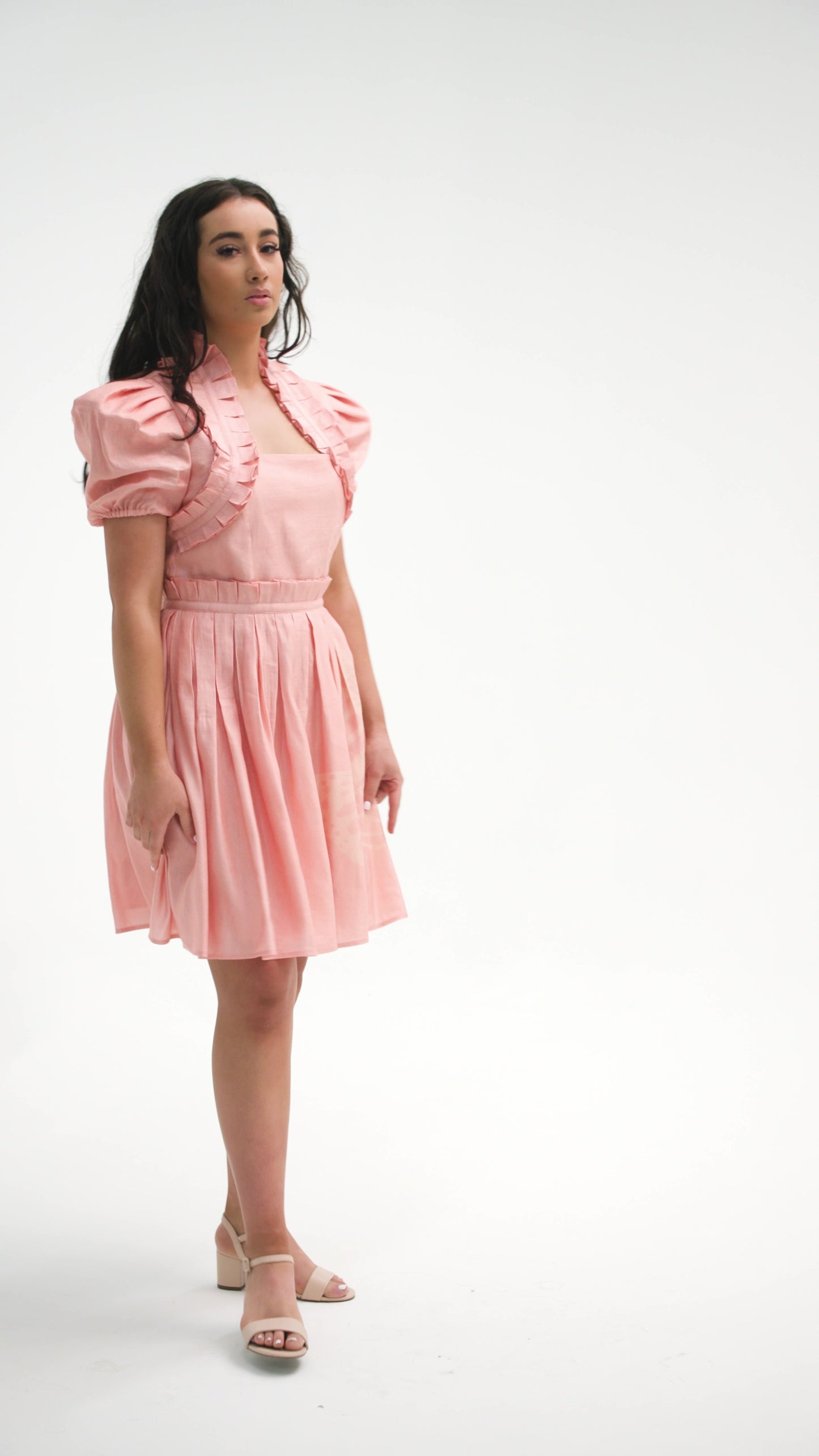 PRODUCT DESCRIPTION   Premium silk cotton linen, unique mini dress with short puff sleeves exclusive to MAZASHIE.  Pastel colour mini dress with Asymmetrical Placement prints on the voluminous skirt.  Pleated neck ruffles add a luxurious look to the dress.  Pleated paper bag detail at skirt waist.  Princess seams make a perfect fit.  The elasticated waist makes a perfect fit.  Invisible back zip closure.