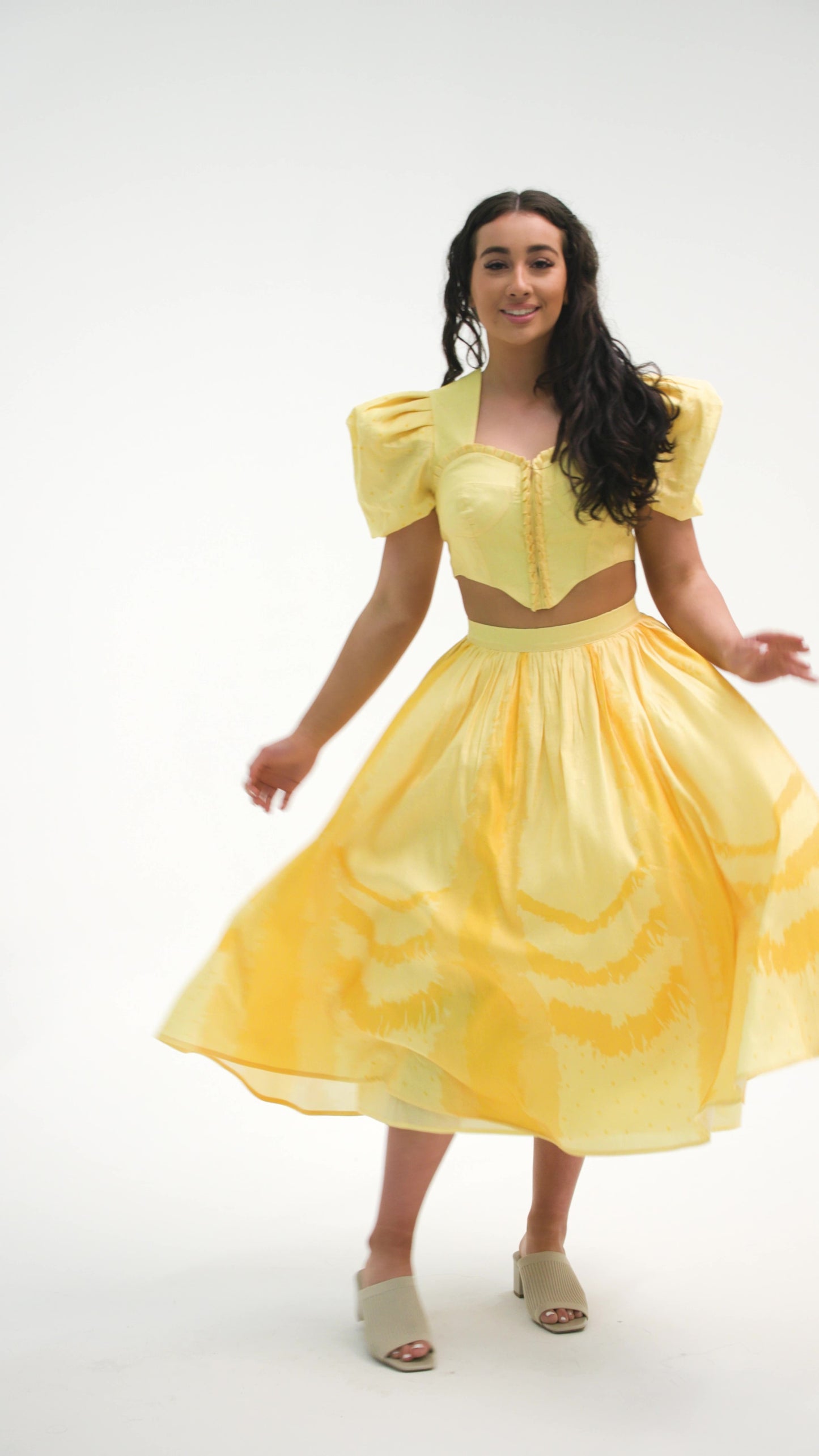 PRODUCT DESCRIPTION   Premium silk cotton linen, Daffodil-Yellow unique 2-piece midi dress with short puff sleeves exclusive to MAZASHIE.  Sweetheart neck, crop top with shirred back and bra-cut detail.  Placement prints on the voluminous skirt and polka-dotted puff sleeves.  The elasticated skirt waistband makes a perfect fit.  The shirred back band makes a perfect fit.  Invisible back zip closure at skirt.  Side seam concealed pockets.  Hooks and eyes closure at front.